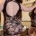 Sexy black sheer mesh cheongsam style bodycon outfit for women, featuring intricate lace patterns and a daring back design.