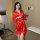 A woman stands elegantly holding a rose, wearing a vibrant red ice silk robe with lace detailing. the luxurious bathrobe exud...
