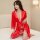 A woman poses elegantly in a vibrant red ice silk robe, featuring lace detailing and a deep v-neckline, perfect for luxurious...