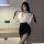 Woman in white blouse and black secretary skirt holding a tie, perfect for office chic or nightclub outfits.