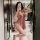 Woman in pink lace-trimmed slip dress posing in bathroom mirror, showcasing plus size sexy sleepwear for women - busty allure...