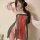 Woman wearing a red and green tang dynasty print bandeau dress with sheer sleeves, styled as sexy hanfu-inspired lingerie.