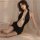 Woman wearing black backless halter bodysuit with pearl chains, sexy nightclub bodycon dress for women.