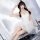 A woman poses elegantly in a white sheer ballet-inspired lingerie dress, featuring delicate lace and angel wings, perfect for...