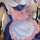 A detailed view of a cat-themed maid costume, featuring a pink bow, white apron with paw prints, and a striped dress, perfect...