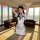 A woman models a white chinese-inspired sleep dress featuring high neck and side slit design, perfect for small busts, set in...
