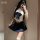 A person wearing a white crop top with a navy blue bow and pleated skirt, paired with sheer stockings, posing for a mirror se...