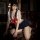 A woman poses in a sailor-style babydoll nightwear set featuring lace trim and a prominent red bow detail, perfect for intima...
