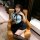 A woman wearing a navy sailor collar outfit with a cute short skirt, sitting on an orange chair. the ensemble features black ...