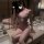 Woman wearing pure & alluring lace lingerie set – flirty babydoll with ruffled hem, posing in bathroom mirror.