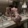 Woman in pure & alluring lace lingerie set – flirty sensual babydoll with ruffled hem, kneeling on bathroom counter.