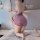 Woman kneeling on bed in purple lace lingerie set with butterfly pattern, back view of qqny cheongsam-inspired sleepwear.