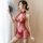 Woman in red sheer cheongsam lingerie with lace details and halter neck, holding a decorative fan.