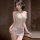 Woman wearing pure & alluring sheer mesh lace cami sleep dress with deep v-neck and adjustable straps, posing indoors.