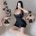 Woman posing in black silk-look babydoll nightgown with backless design, sheer lace trim, and flirty skirt—perfect for sensua...