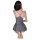 Woman wearing backless gray silk-look babydoll nightgown, kneeling with hand near neck.