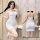Woman modeling white floral v-neck bodysuit with adjustable straps, shown front and back views.