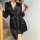 A woman elegantly poses with a rose, wearing a sleek black sleep dress made from lightweight ice silk fabric. the dress featu...
