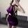 Woman wearing a purple velvet pure & dark lingerie set, styled as a sexy witch cosplay sleep dress for role play.
