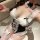 Woman wearing white lace pure & playful bunny girl lingerie set with black bow accents, thigh-highs, and choker — sexy, sensu...