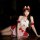 A woman poses wearing a festive christmas maid outfit, featuring a strapless design with red and white colors, cute antler he...