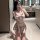 Woman in pure & playful jk sleepwear set taking a mirror selfie. sensual plaid lingerie with bow top and skirt.