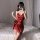 Woman in red satin chemise nightgown with adjustable straps, posing on bed. seductive sleepwear for women.
