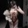Woman in pure & playful lingerie bodysuit holding teddy bear, soft cute open-crotch sleepwear with adjustable straps.