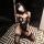 Woman in black lace bunny girl lingerie set with ears, sitting on geometric floor. sensual, seductive outfit with luxe feel.