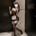 Elegant maid costume featuring sheer black bodice with red accents, white apron, and thigh-high stockings, perfect for sensua...