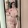 Pink nurse-themed lingerie set with crop top, pleated skirt, and lace stockings for a playful, seductive look.