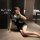 Woman posing in black nurse-themed lingerie set with cross emblem, short dress, and cap—seductive costume-inspired sleepwear ...