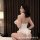 Woman in white maid-themed lingerie set with fluffy collar and cuffs, posing seductively on bed for romantic nights.
