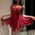 Woman wearing red lace lingerie set, flirty and feminine sleepwear with sheer fabric and bow detail.