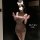 Woman wearing pure & playful lingerie set - seductive naughty costume sleepwear with bunny ears, posing in a dimly lit room.