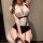 Woman wearing white and black secretary-style lingerie set with garter straps, posing seductively on a stool for romantic nig...