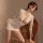 Woman wearing white lace lingerie set with bodycon skirt, posing on vintage chair. pure & playful lingerie set - seductive se...