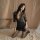 Woman kneeling on bed in black lace pure & playful lingerie set — seductive secretary sleepwear with sheer sleeves and deep v...