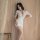 Woman in white lace lingerie set with sheer sleeves and deep v-neck, styled as seductive secretary sleepwear.