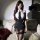 Woman wearing pure & playful lingerie set, featuring a white halter top with black tie and matching high-waisted shorts with ...