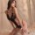 Woman wearing black lace bodysuit lingerie set, seductive sleepwear for intimate moments.