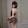 Woman modeling pure & playful lingerie set: sensual jk-style pleated mini skirt with matching top, sexy schoolgirl look.
