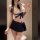 Woman wearing pure & playful lingerie set: sexy jk-inspired sleepwear with lace bra, navy bow, pleated skirt, and thigh-highs...