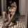Woman wearing pure & playful lingerie set, a sexy secretary-inspired sleepwear with lace details and fishnet stockings, posin...