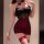 Woman wearing a black and burgundy sheer bodysuit with rose details and a hip-hugging skirt from the pure & playful lingerie ...