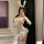 Woman in mirror wearing sheer white bunny girl lingerie set with lace, ears, and blue bow garters.