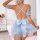 Woman wearing a light blue pure & playful lingerie sleep dress with a large bow, cross-back straps, and ruffled sleeves in a ...