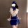 Woman in a blue and white flight attendant-inspired pure & playful lingerie sleep set, holding a feathered wand.