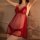 Woman wearing red sheer lingerie sleep dress with polka dots and fluffy trim, flirty bedroom wear for women.