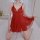 Woman in red sheer lingerie sleep dress with lace details, kneeling on bed, showcasing flirty and sensual design.